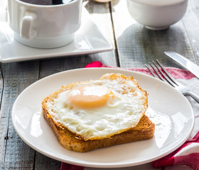 crispy toast with a fried egg and a cup of coffee. English break