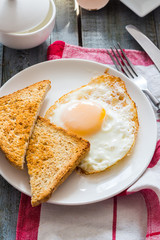 crispy toast with a fried egg and a cup of coffee. breakfast