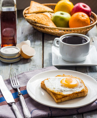 crispy toast with a fried egg and a cup of coffee, fruit, breakf