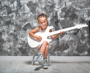 beautiful little girl with her guitar