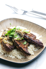 fried livres with mushroom sauce and rice