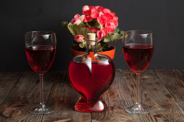 Bottle with red wine and flower