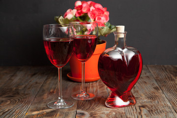 Bottle with red wine and flower