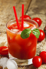 Red cocktail with tomato juice, ice and salt, selective focus