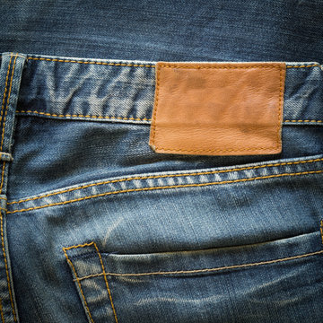 blue jeans with back pocket and brown leather tag