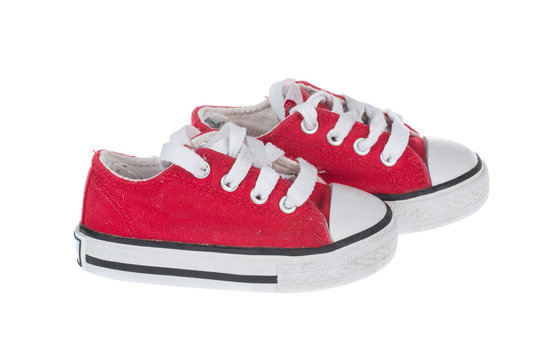 Cute red baby sneakers, isolated on white