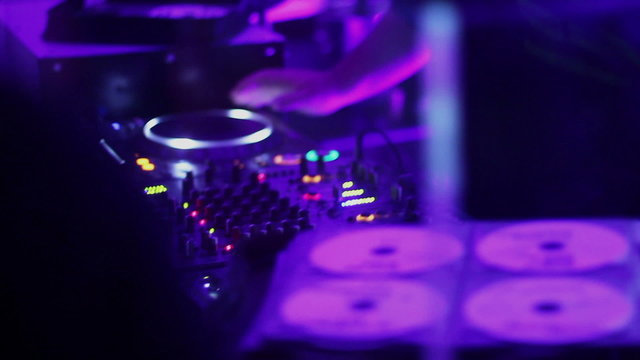 Man, deejay working, mixing music, CD records, sound equipment