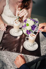Bride and groom in luxurious restaurant drink a cup of Coffee