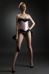 BDSM. Domineering woman posing in sexy lingerie