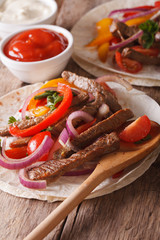 Mexican food: tortilla with meat and vegetables. vertical