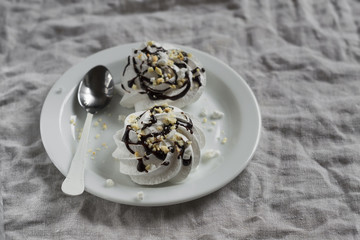 meringue with chocolate sauce and nuts