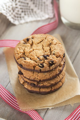 Pile of chocolate cookies with a glass of milk