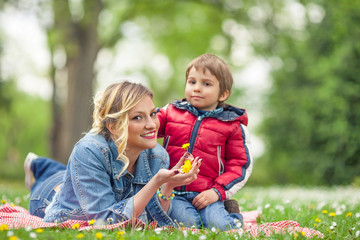 Beautiful young mother playing with her son 