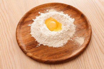 Broken egg on flour