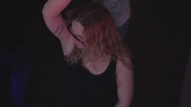 Young girl moving on nightclub dance floor, overweight problem