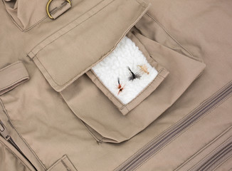 Three fly fishing flies on fleece patch with vest