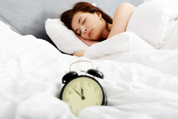 Woman sleeping in bed.