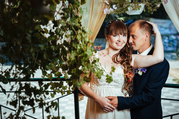 young bride and groom in the park, bridal bouquet, wedding