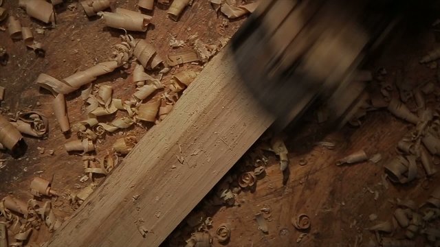 Man hands with carpenters plane production of oak barrels