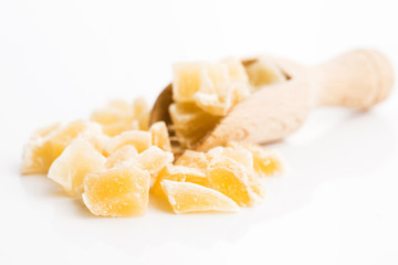 Caramelized ginger candy pieces isolated on white background