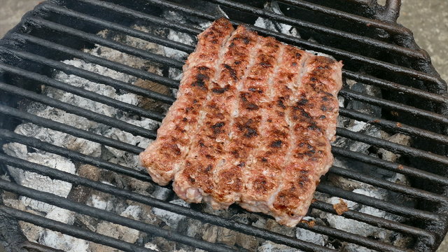 Barbecue preparing grilling kebab cevapcici in Balkan countries