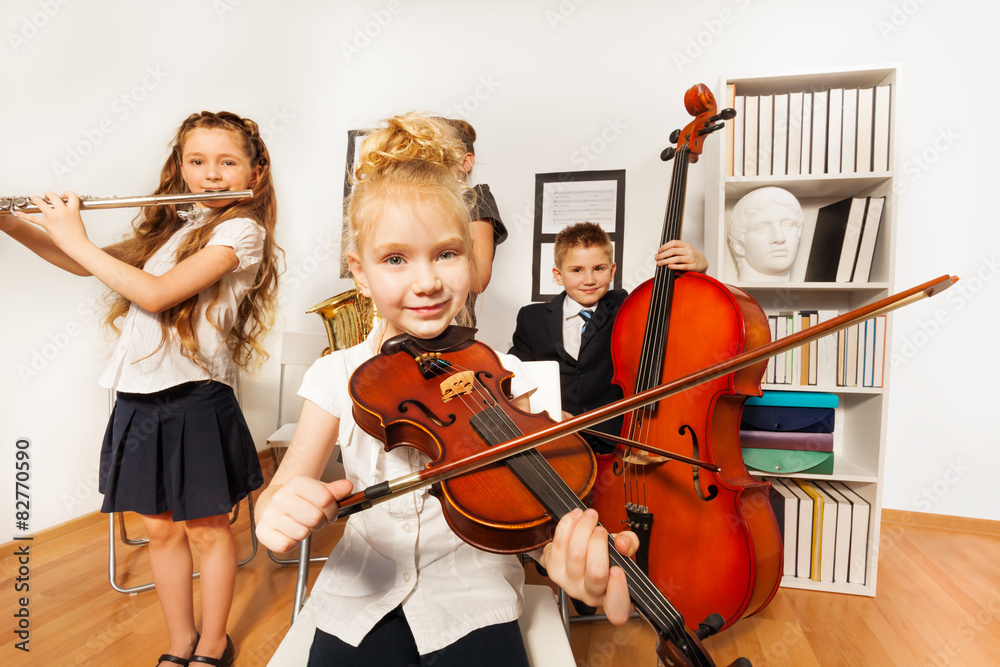 Wall mural performance of kids who play musical instruments