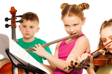 Group of cute kids playing on musical instruments
