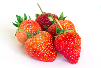 Ripe strawberries on a white background