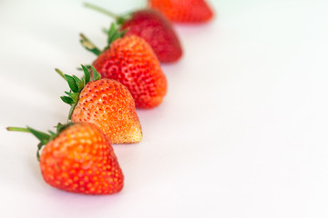 Close up row  Ripe strawberries on a white background