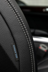 Airbag label on the side of a car leather seat.
