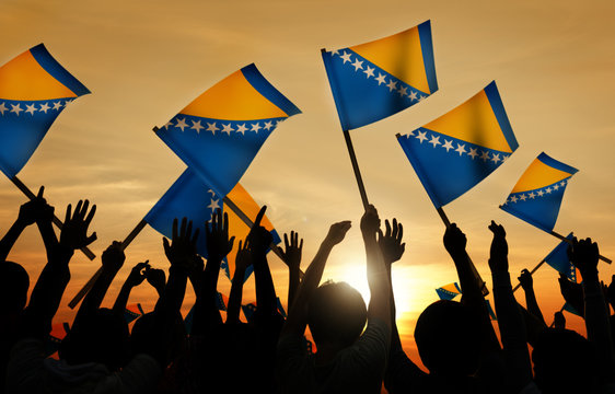 Silhouettes Of People Holding Flag Of Bosnia And Hercegovina