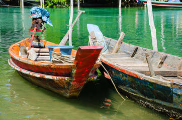Obraz premium Wood Boats of Fisherman Floating On Clear Water In Daylight.