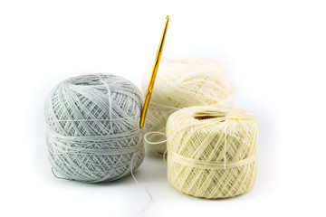 a ball of yarn with crochet isolated on white background