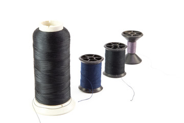 multi-colored r threads for sewing on white background