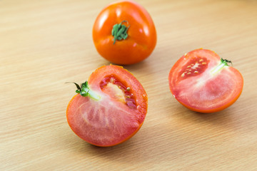 Fototapeta na wymiar fresh Tomatoes on a woodden background