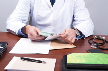 Fototapeta premium A doctor taking a bribe from a patient