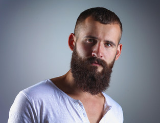 Obraz premium Portrait of handsome bearded man isolated on grey background