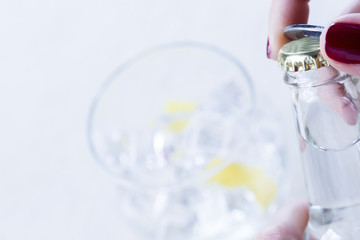 opening a tonic bottle.