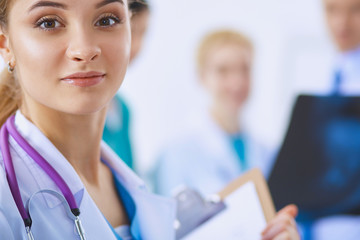 Woman doctor standing with folder at hospital