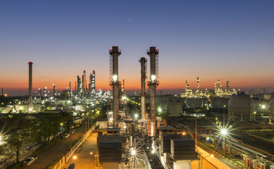 Fototapeta na wymiar Oil refinery plant at sunset, The night view of petroleum and petrochemical factory with distillation column, drum and pipeline. Gas, diesel and chemical business industry is important for economy.