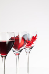 Wine glasses with red wine, heart and golf ball