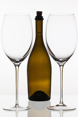 Two empty glasses of wine and brown bottle