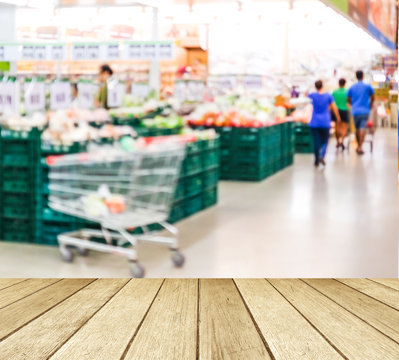 Perspective wood over blur supermarket with people background, p
