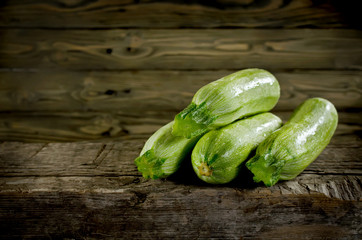 Ripe zucchini and marrow vegetables isolated on wooden backgroun