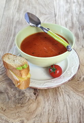 Tomato soup and slices of baguette with cheese