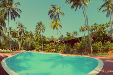 swimming pool at tropical resort - vintage retro style
