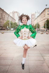 Young woman in irish dance dress and wig dancing © darkbird
