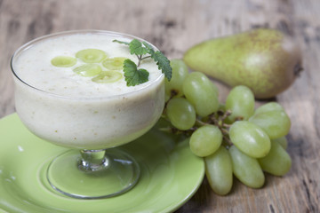 Obraz na płótnie Canvas Smoothies of pears and green grapes with yogurt in a glass bowl