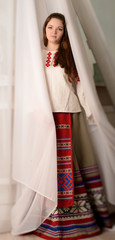 young woman in Slavic Belarusian national original suit studio