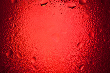 water drops on red background with spotlight center